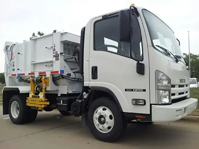 White garbage truck parked on a street, side view with rear lifting mechanism visible