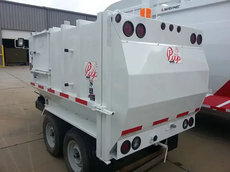 White industrial vacuum truck parked outdoors, with red accents and multiple rear lights.