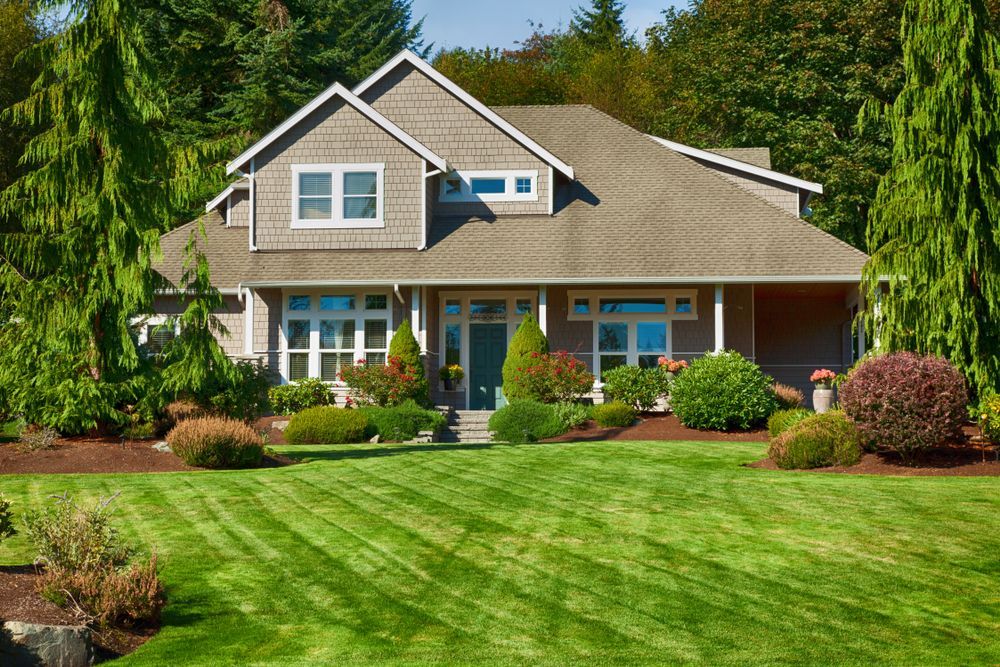 A large house with a lush green lawn in front of it.
