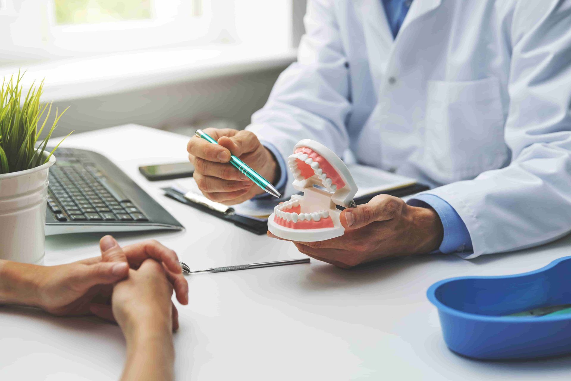 A Dentist is Talking to a Patient — Central Coast Denture Clinic Erina In Erina, NSW