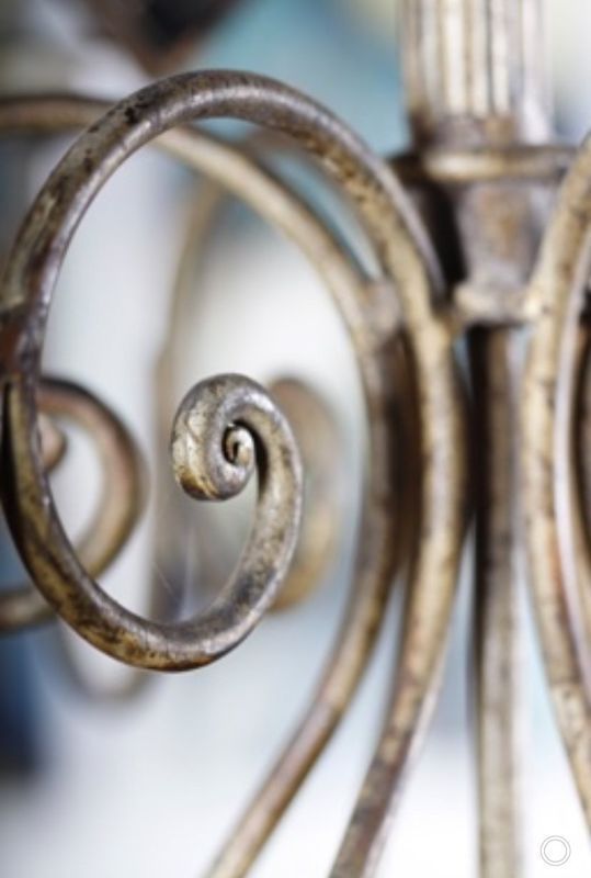 Close-up of a decorative wrought-iron spiral in silver and brown tones
