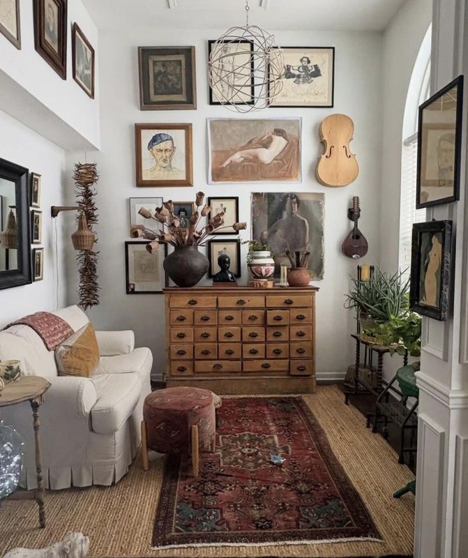 Cozy living room with gallery wall, red rug, wooden dresser, cream sofa, and eclectic decor