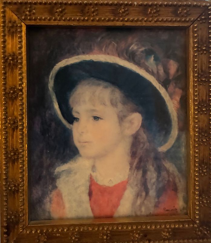 Framed portrait of a child in a dark hat and red clothing, painted in soft brushstrokes