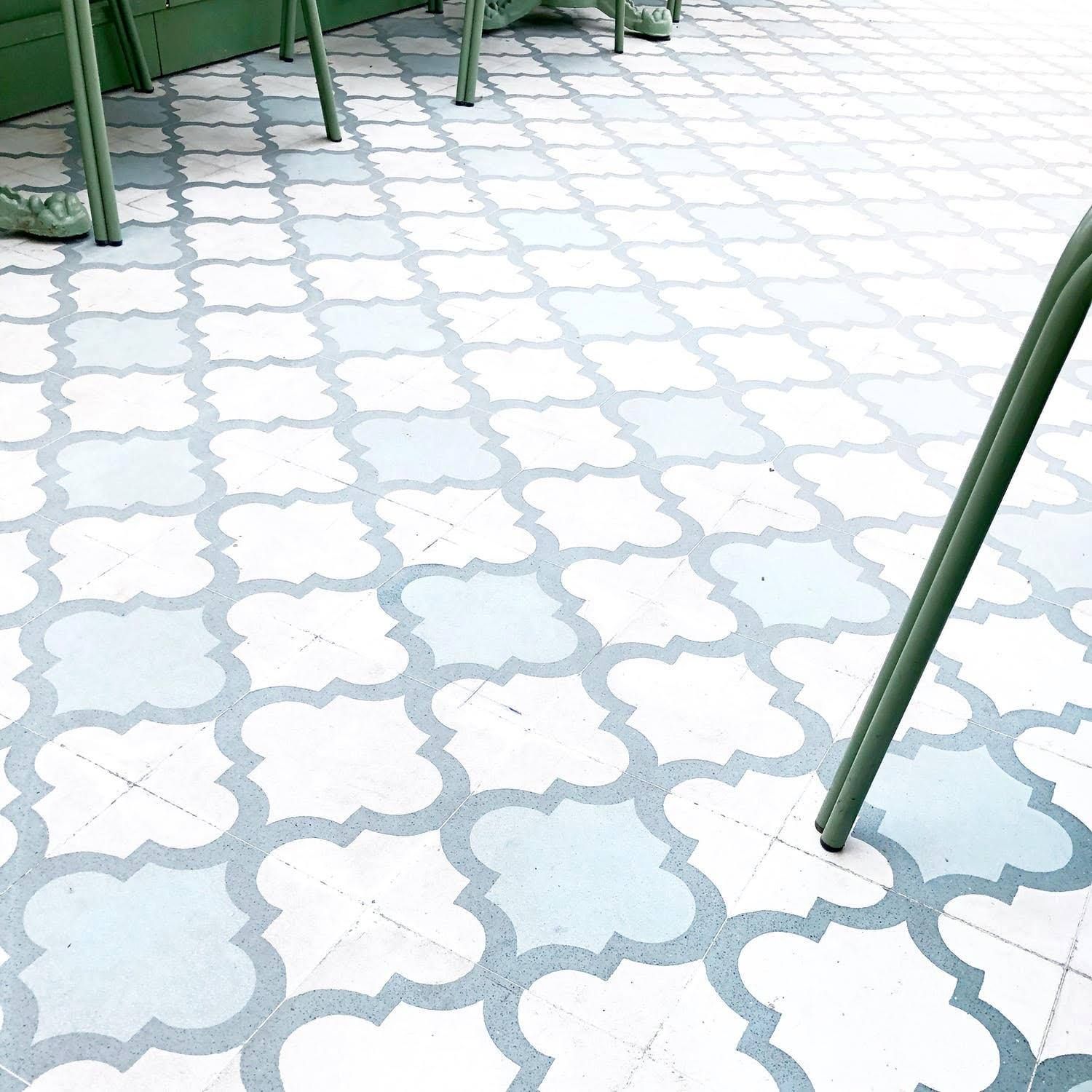 A tiled floor with a geometric pattern on it