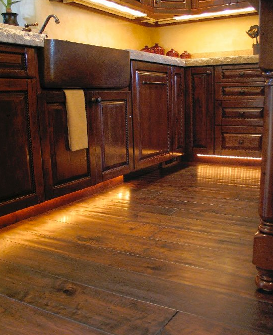 A kitchen with wooden cabinets and a sink