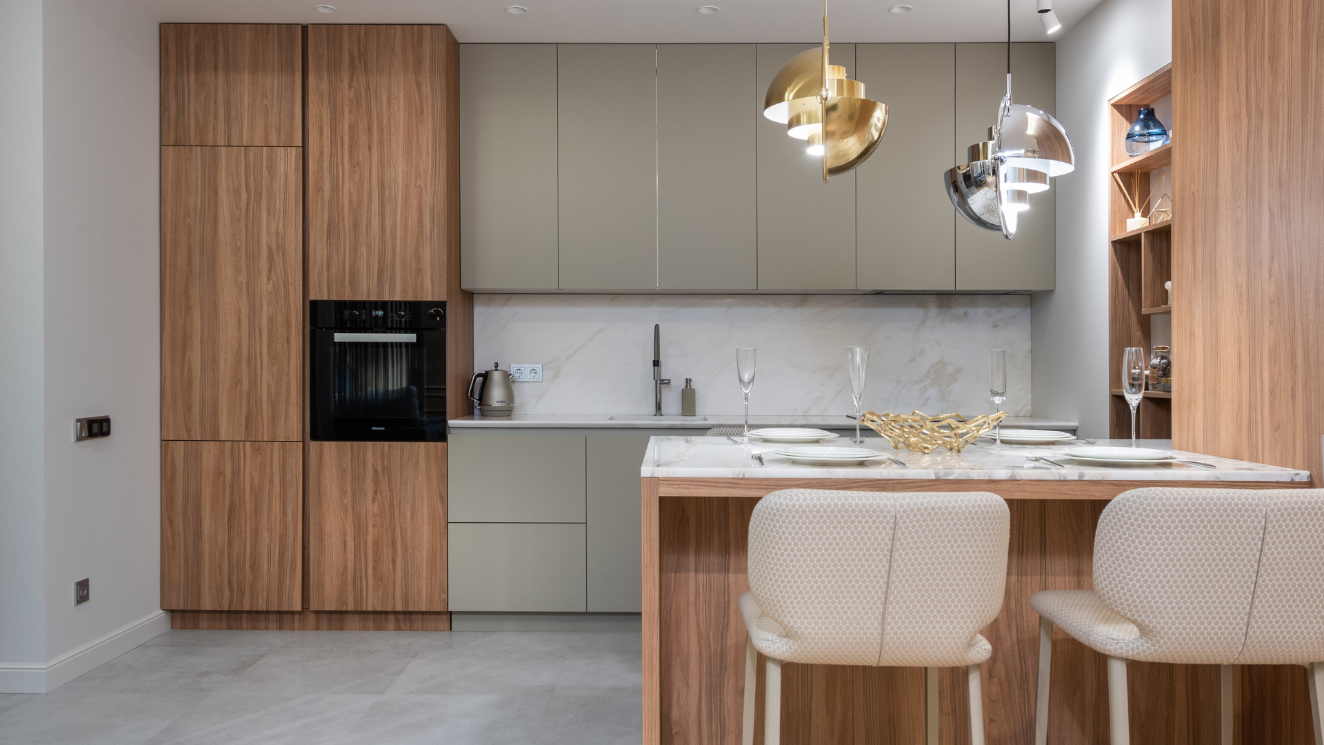 Modern kitchen with wood cabinets, marble island, pendant lights, and woven bar stools