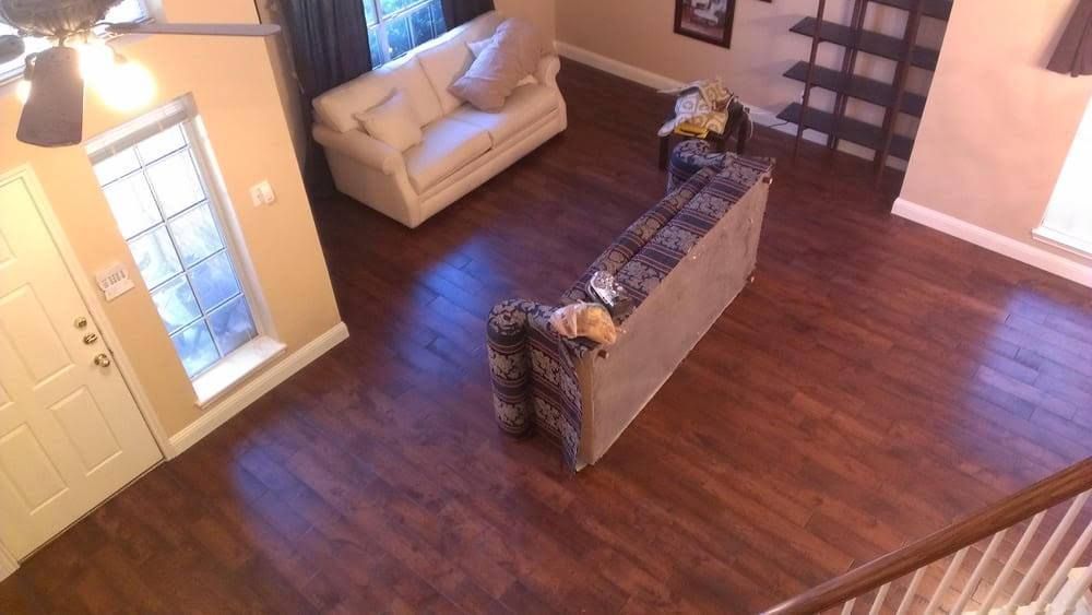 An aerial view of a living room with hardwood floors and a couch.