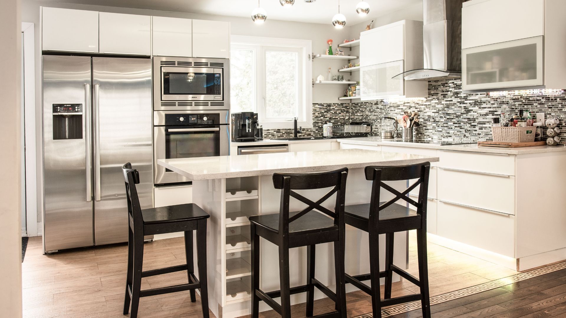 A kitchen with stainless steel appliances and white cabinets