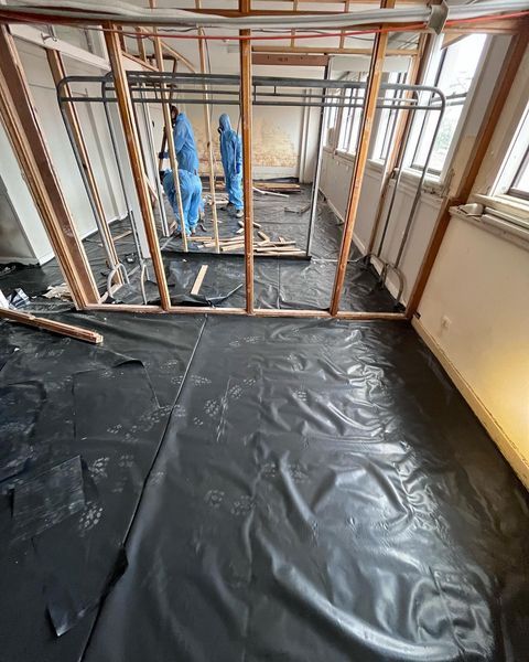 A Room Under Construction with A Black Tarp on The Floor — Northern Rivers Demolition & Asbestos in Grafton, NSW