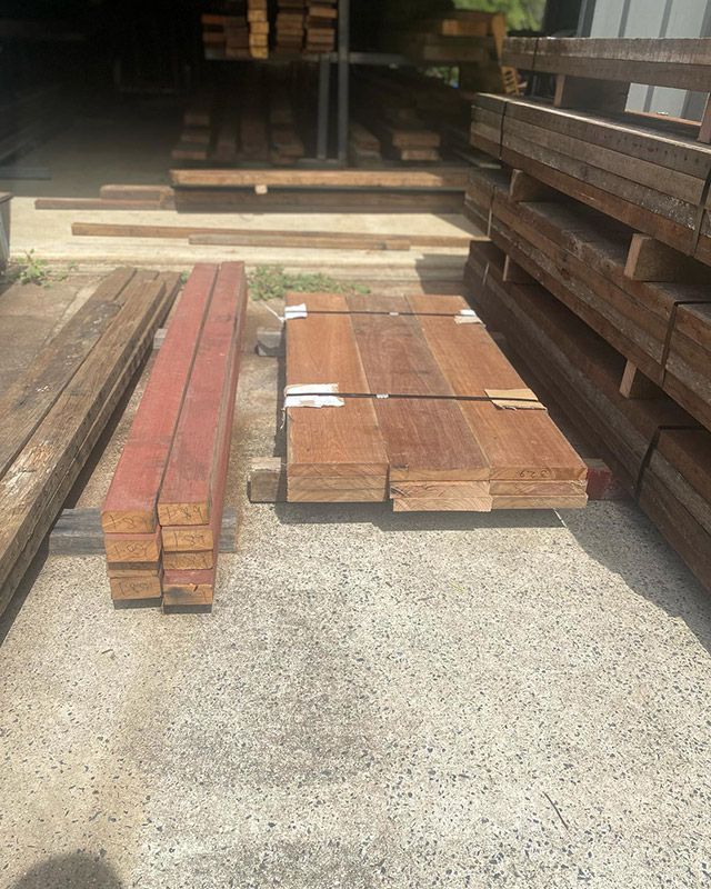 A Pile of Wood Is Sitting on The Ground in A Warehouse — Northern Rivers Demolition & Asbestos in Grafton, NSW
