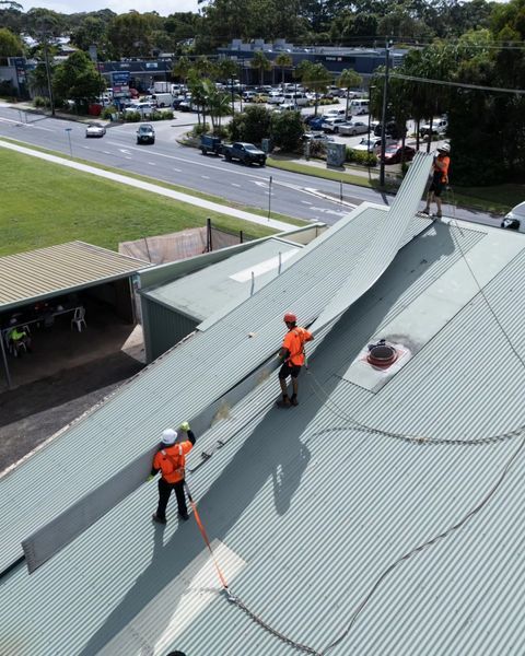 Two Men Are Working on The Roof of A Building — Northern Rivers Demolition & Asbestos in Skennars Head, NSW
