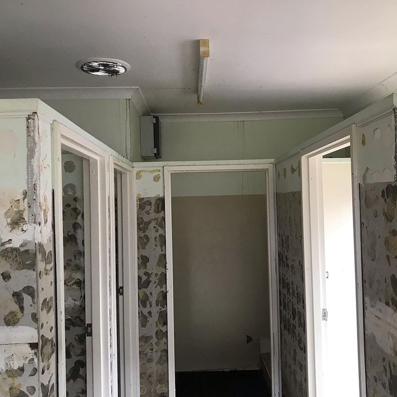 A Hallway with A Lot of Doors and A Ceiling Light — Northern Rivers Demolition & Asbestos in Skennars Head, NSW