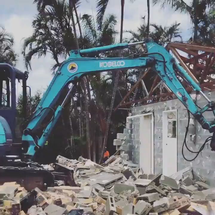 A Kobelco Excavator Is Demolishing a Building — Northern Rivers Demolition & Asbestos in Skennars Head, NSW