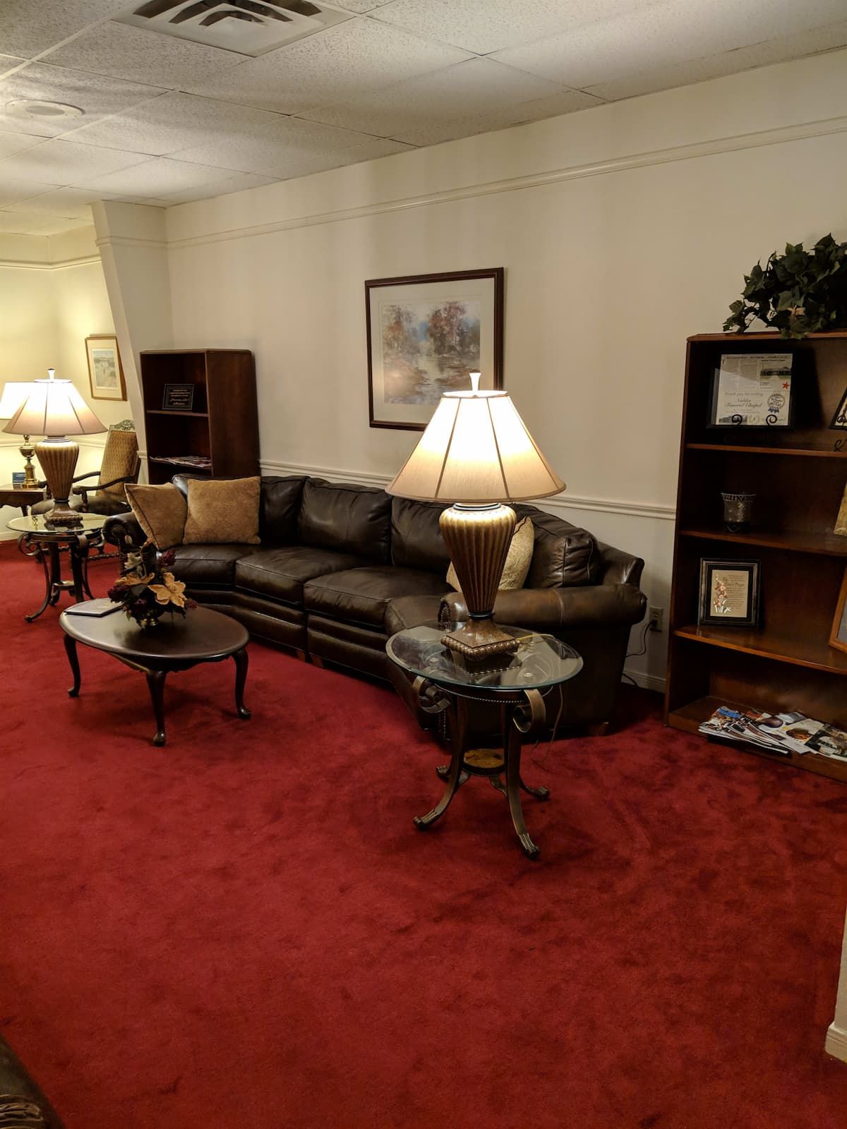 a living room with a couch , table , and lamp