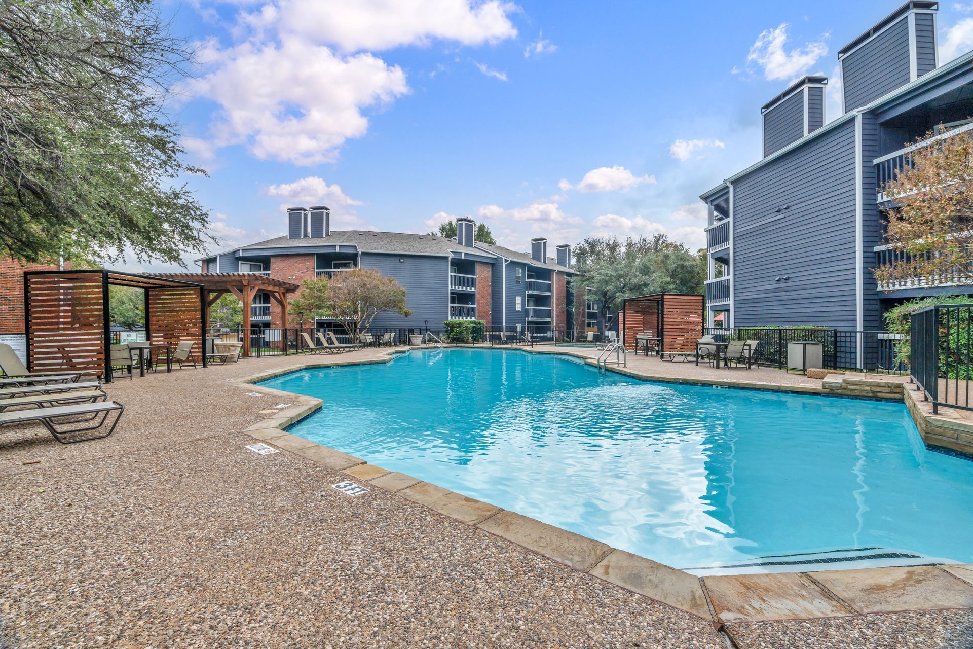 There is a large swimming pool in the middle of a building.