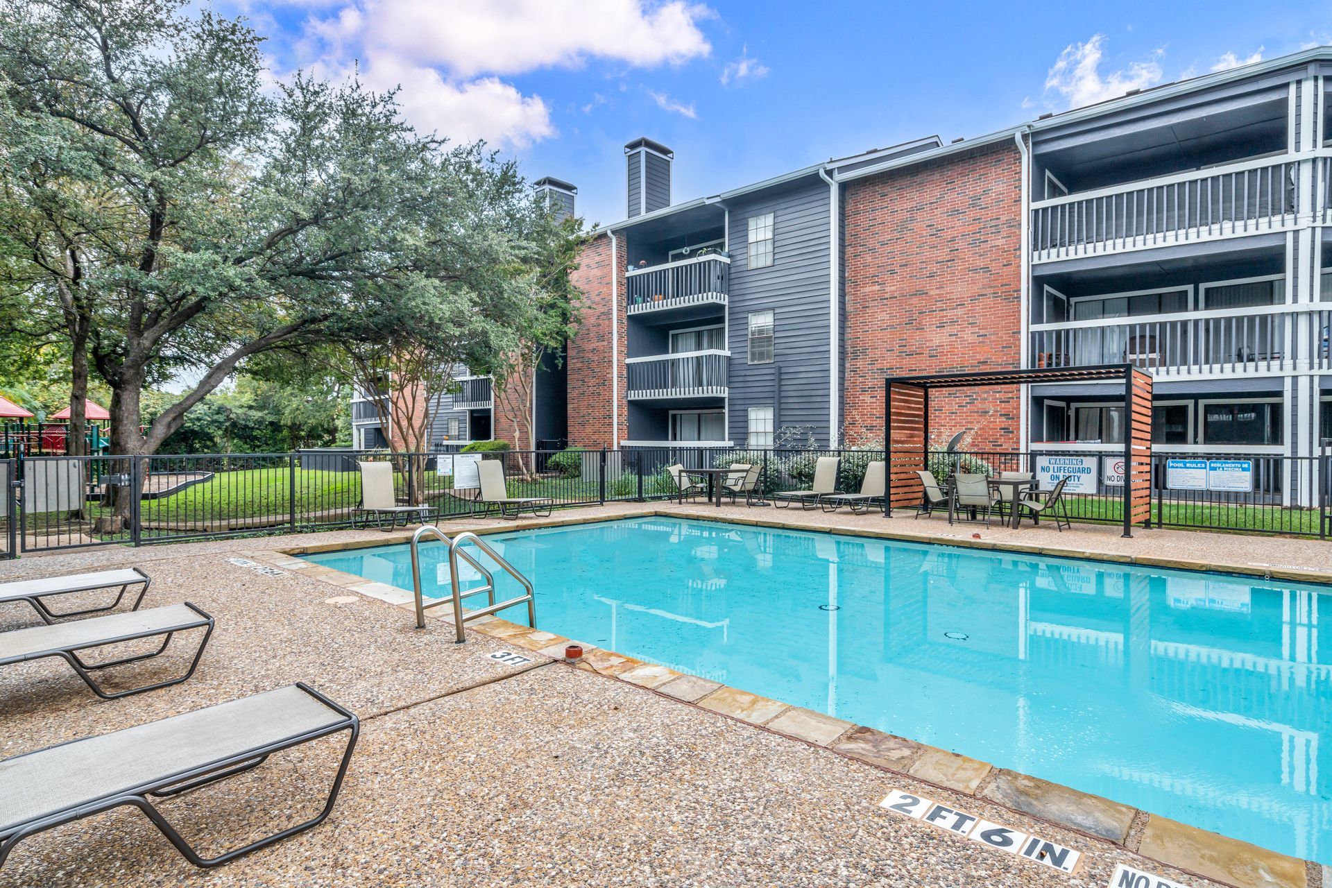 There is a large swimming pool in front of a building.