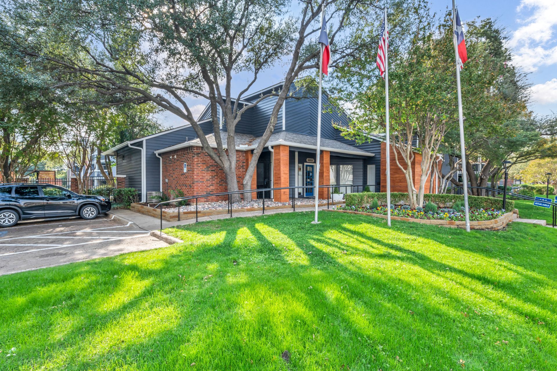 A house with a lot of grass and trees in front of it.