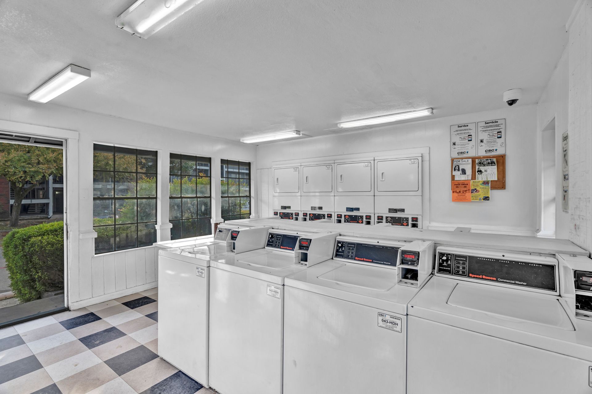 A laundromat with a lot of washers and dryers.