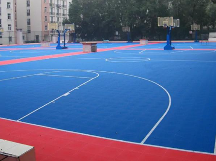 “Large blue and red basketball court with fresh lines and multiple hoops after a court builder service in Tucson, AZ”