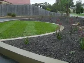 There is a circular lawn in the middle of the yard. There is a circular lawn in the middle of the yard.