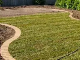 A brick walkway going through a lush green lawn. A brick walkway going through a lush green lawn.