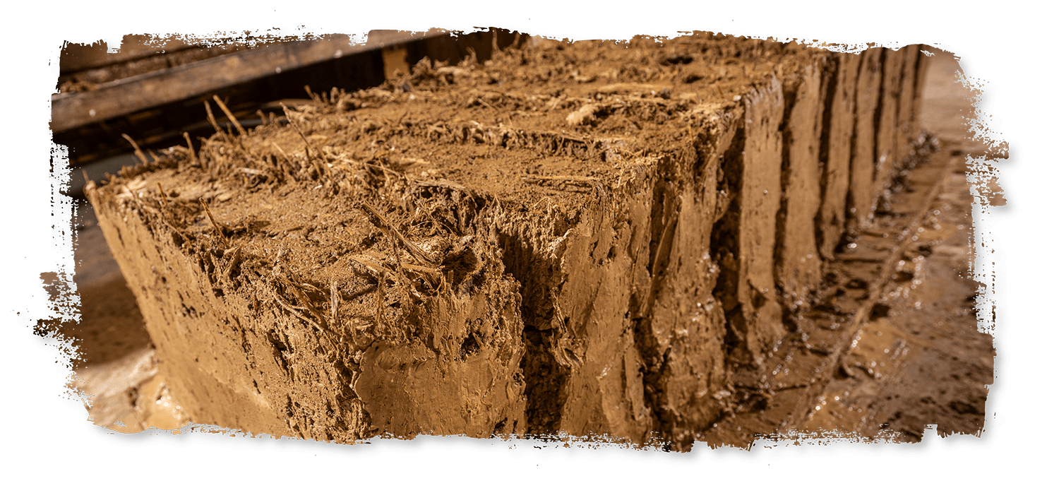 A stack of clay bricks sitting on top of each other on a table.