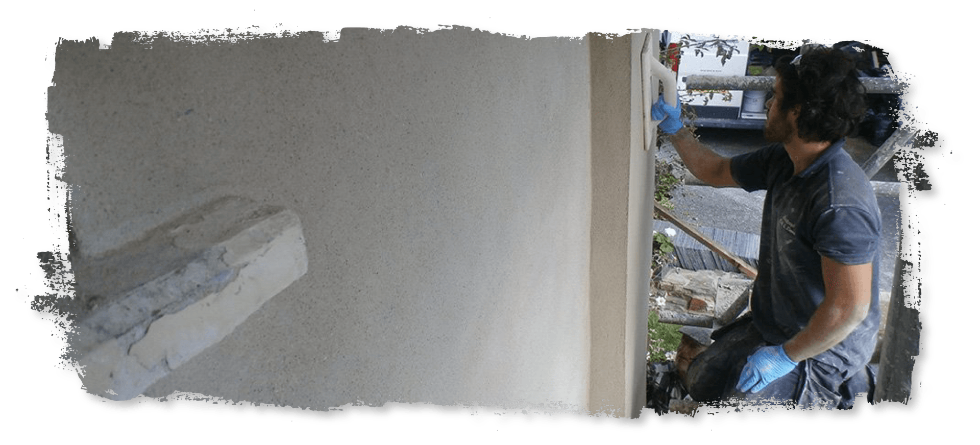 A man is painting a wall with a roller