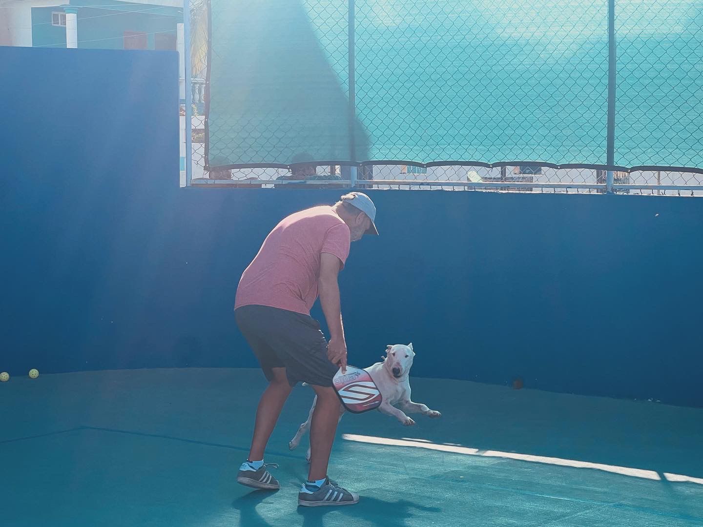 expat helping clean pickblall court in playa del caemen, MD