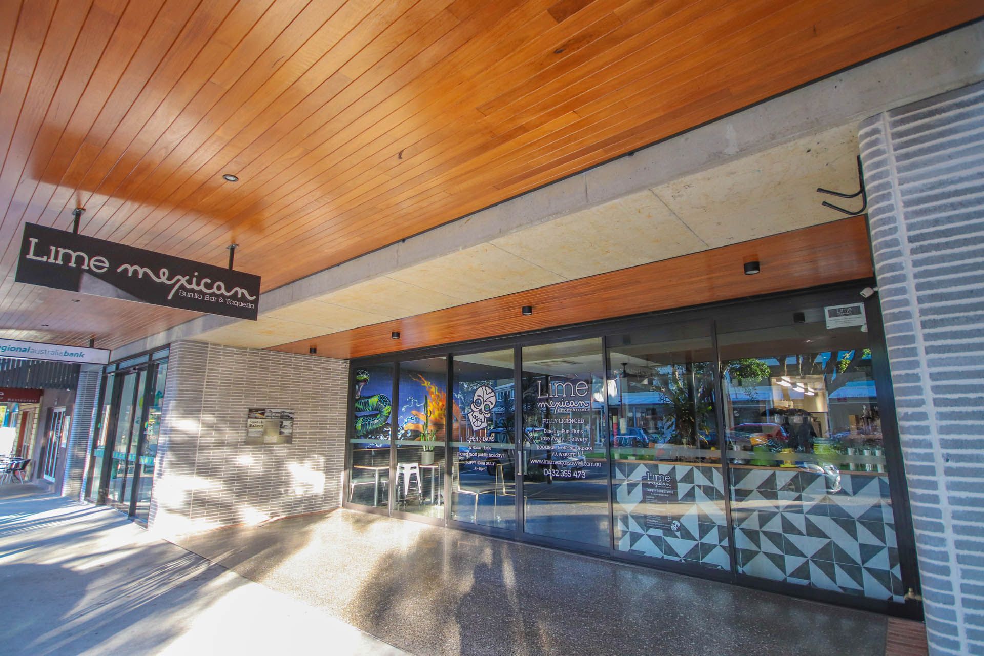 Lime Mexican restaurant storefront with glass doors and sign— Ray Smith Electrical in Korora, NSW
