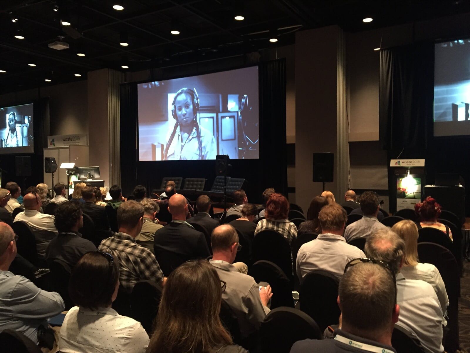 A Group Of People Are Sitting In Front Of A Large Screen Watching A Presentation — Rme in Sapphire, NSW