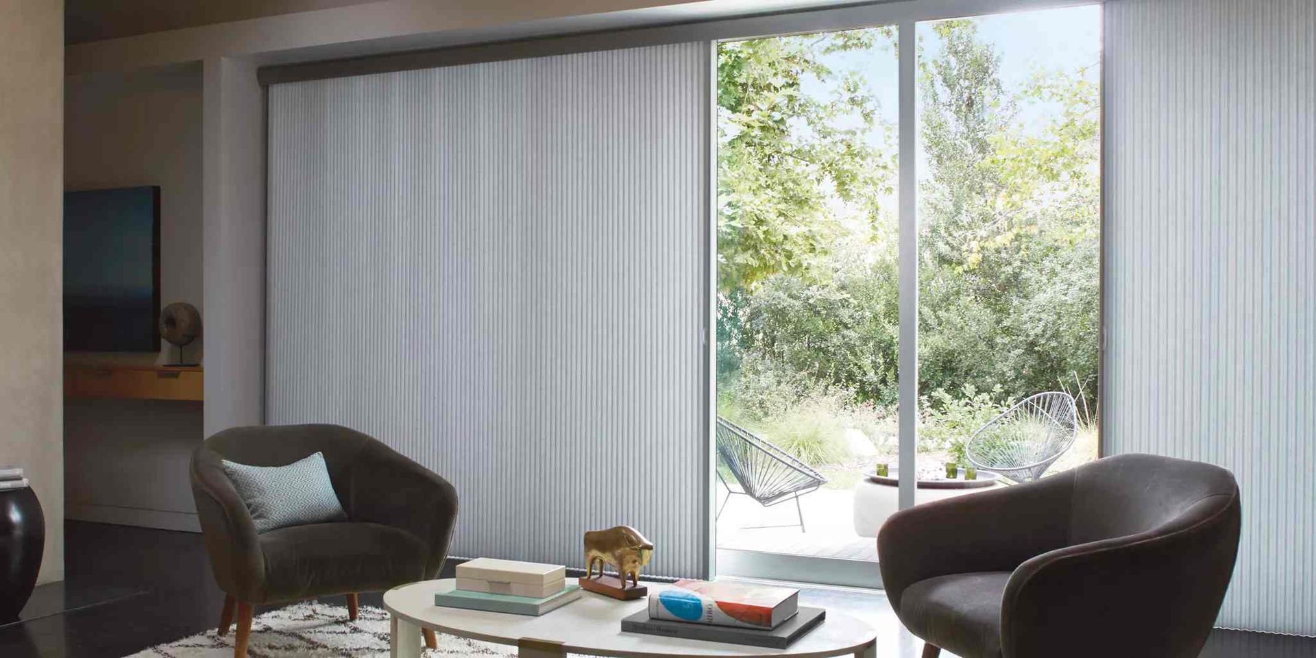 Hunter Douglas sliding door window treatments in a modern living room at Elden Draperies, Blinds and Shades near Toledo, OH.