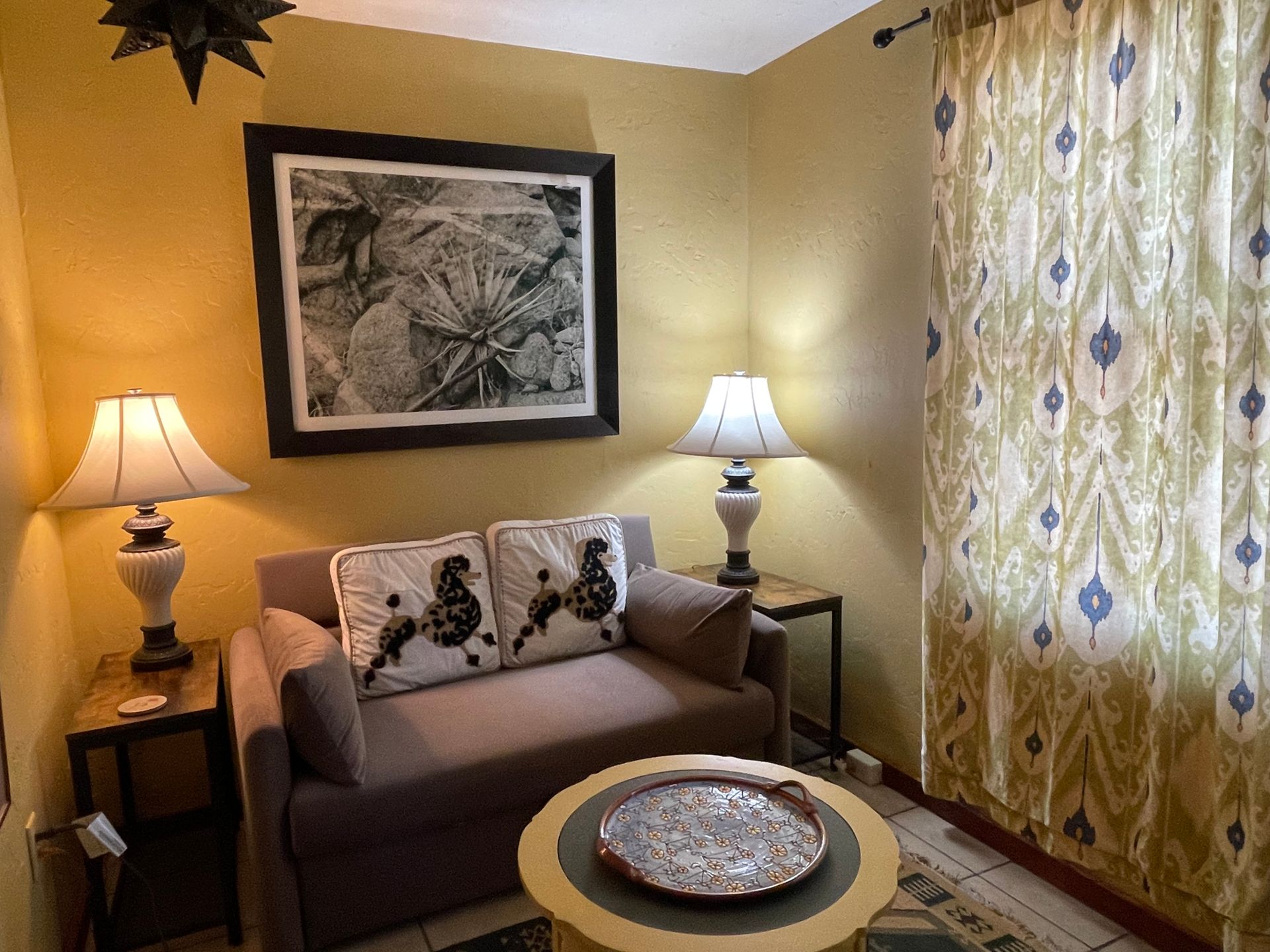 A living room with a couch and two lamps