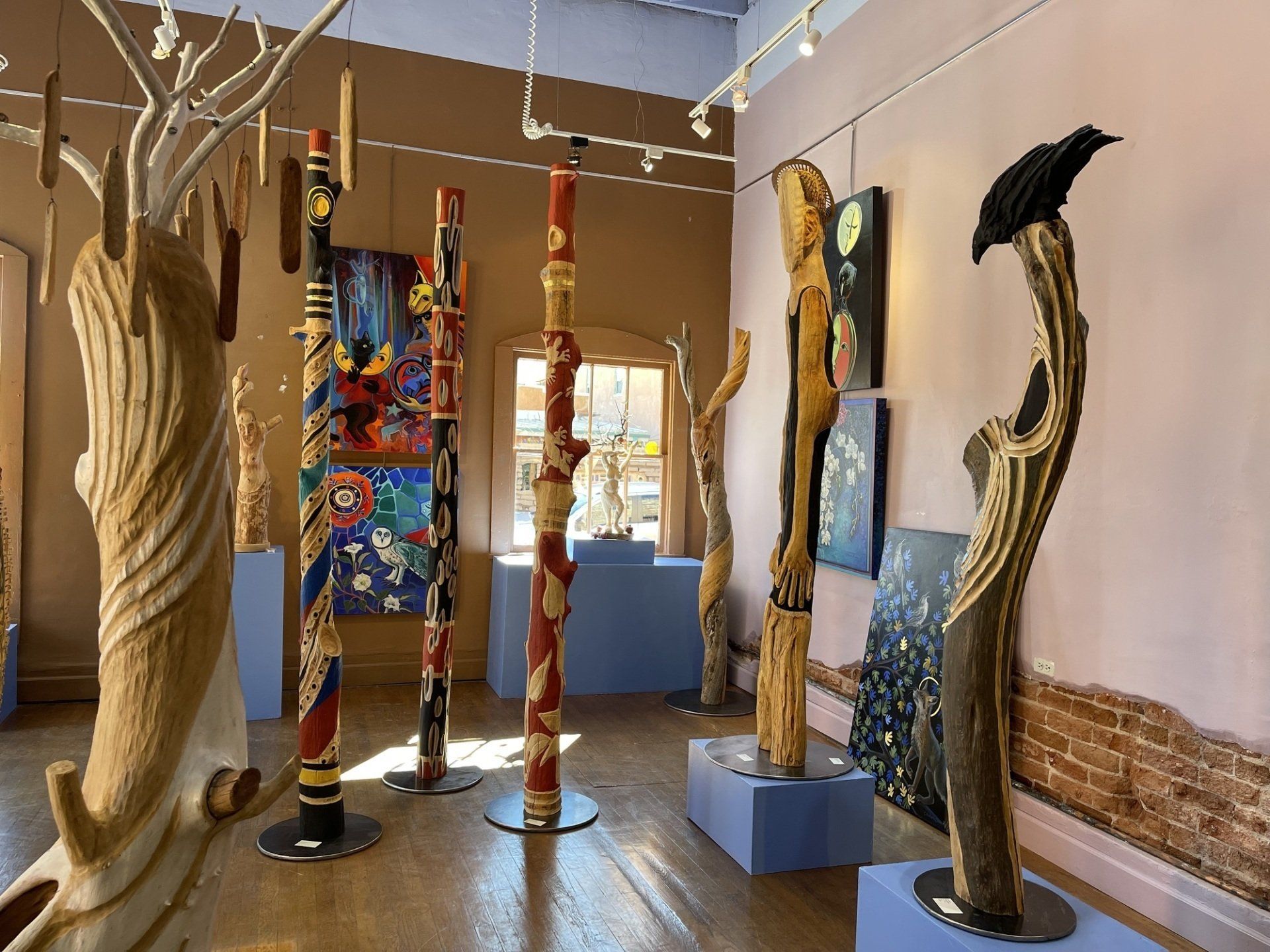 a room with a lot of sculptures and paintings on the wall