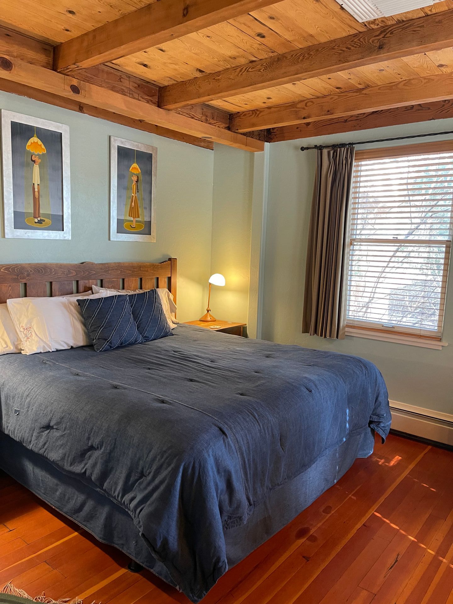 A bedroom with a king size bed and a wooden ceiling.