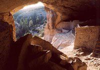 the sun is shining through the window of a cave .
