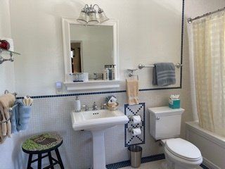 A bathroom with a sink toilet and mirror
