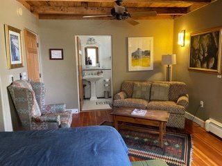 A living room with a couch a chair and a table