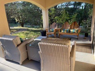 A porch with wicker furniture and a couch