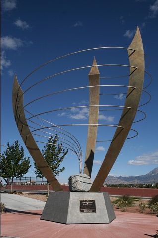 A large sculpture with a blue sky in the background