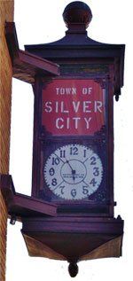 A clock that says town of silver city on it