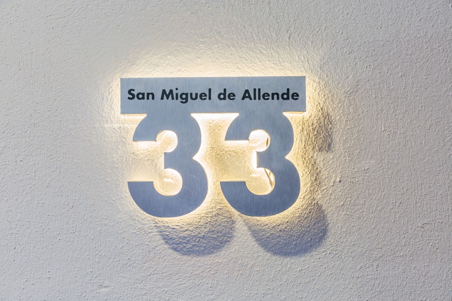 El número 33 está en una pared blanca.