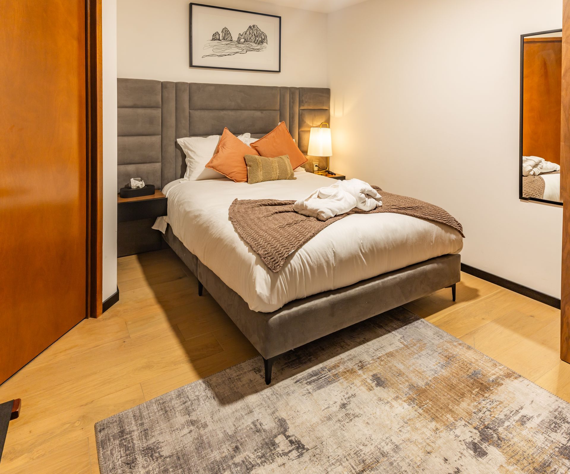 Una habitación de hotel con una cama grande y una alfombra.