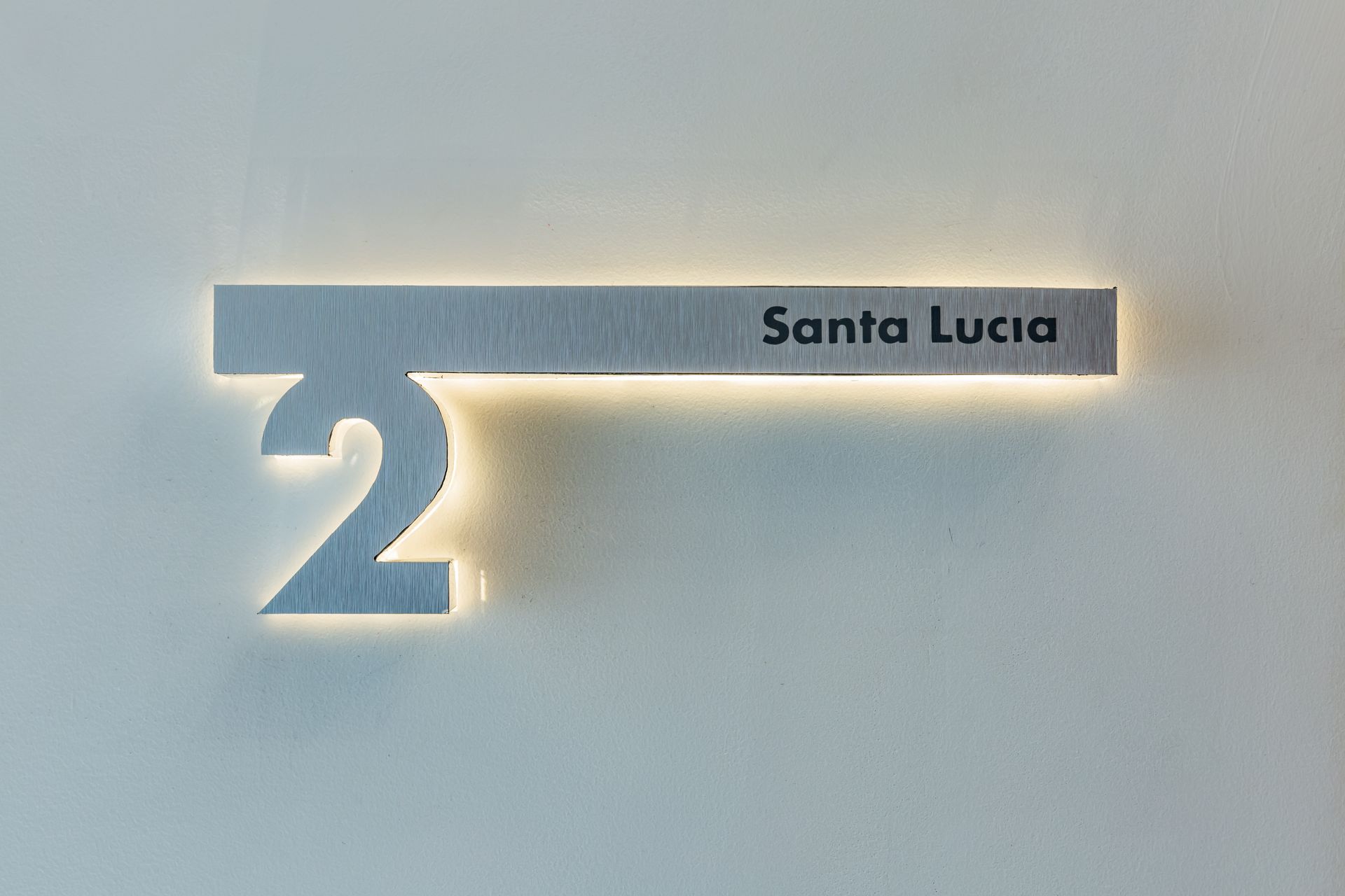 A sign on a wall that says santa lucia on it