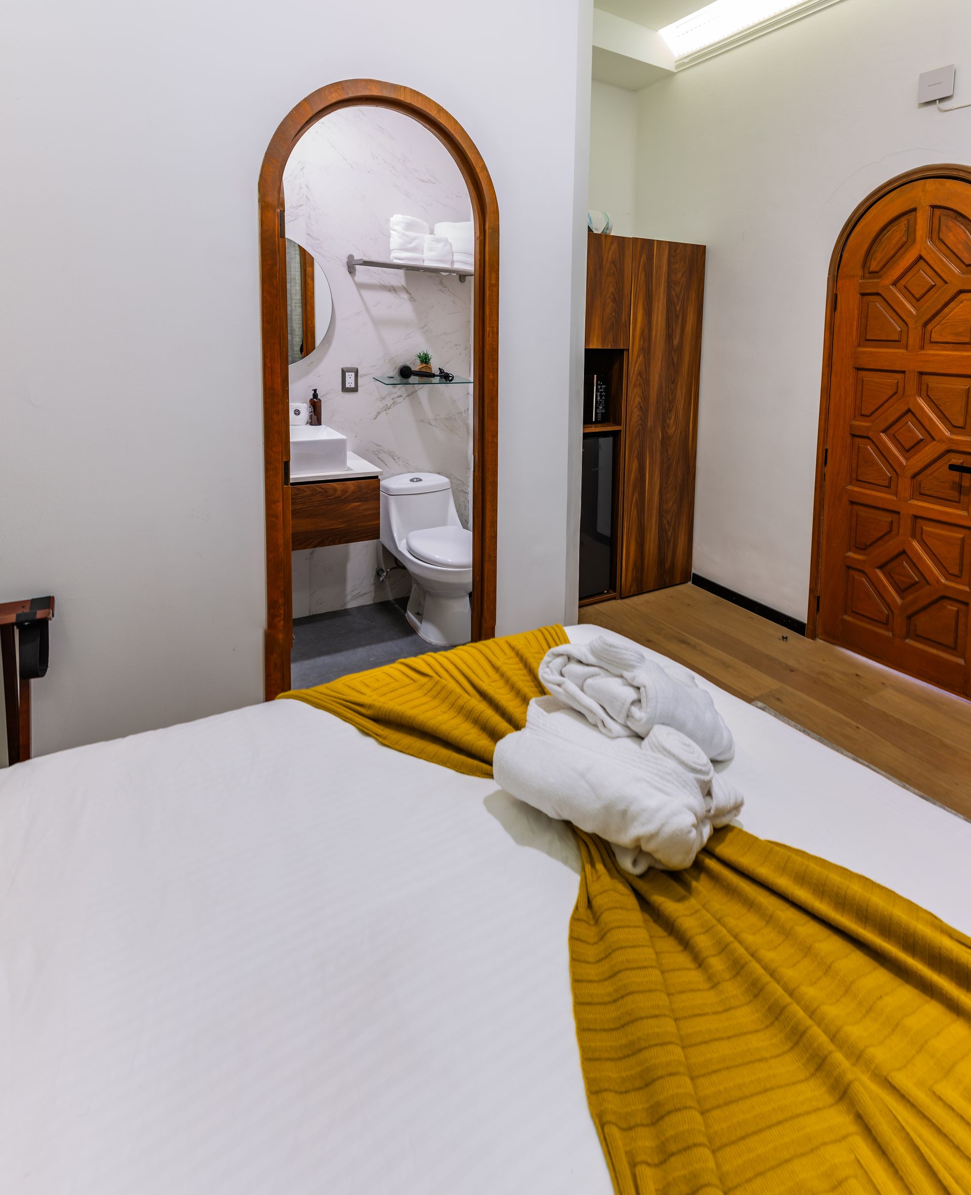 A hotel room with a bed and a toilet