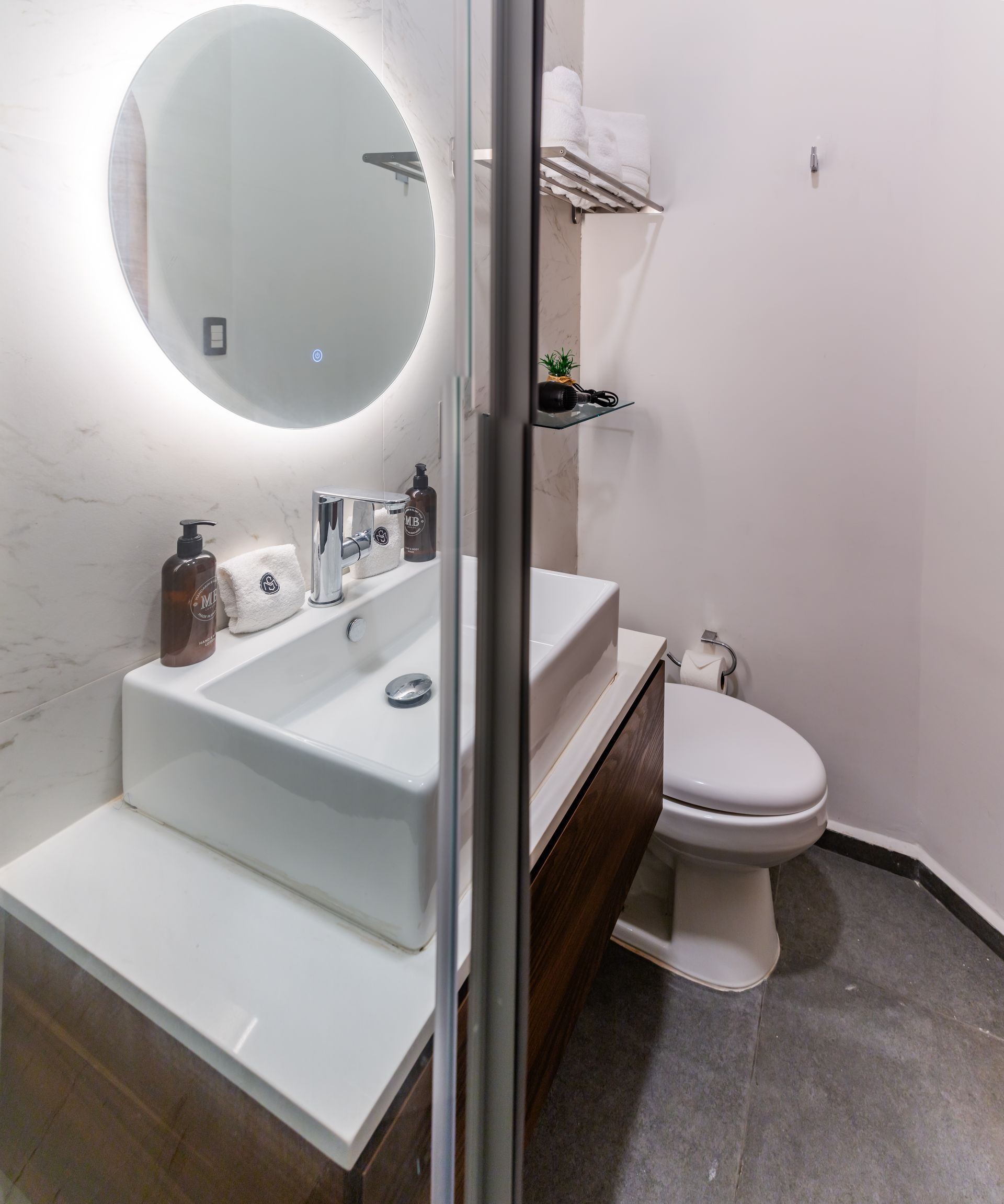 A bathroom with a sink , toilet and mirror