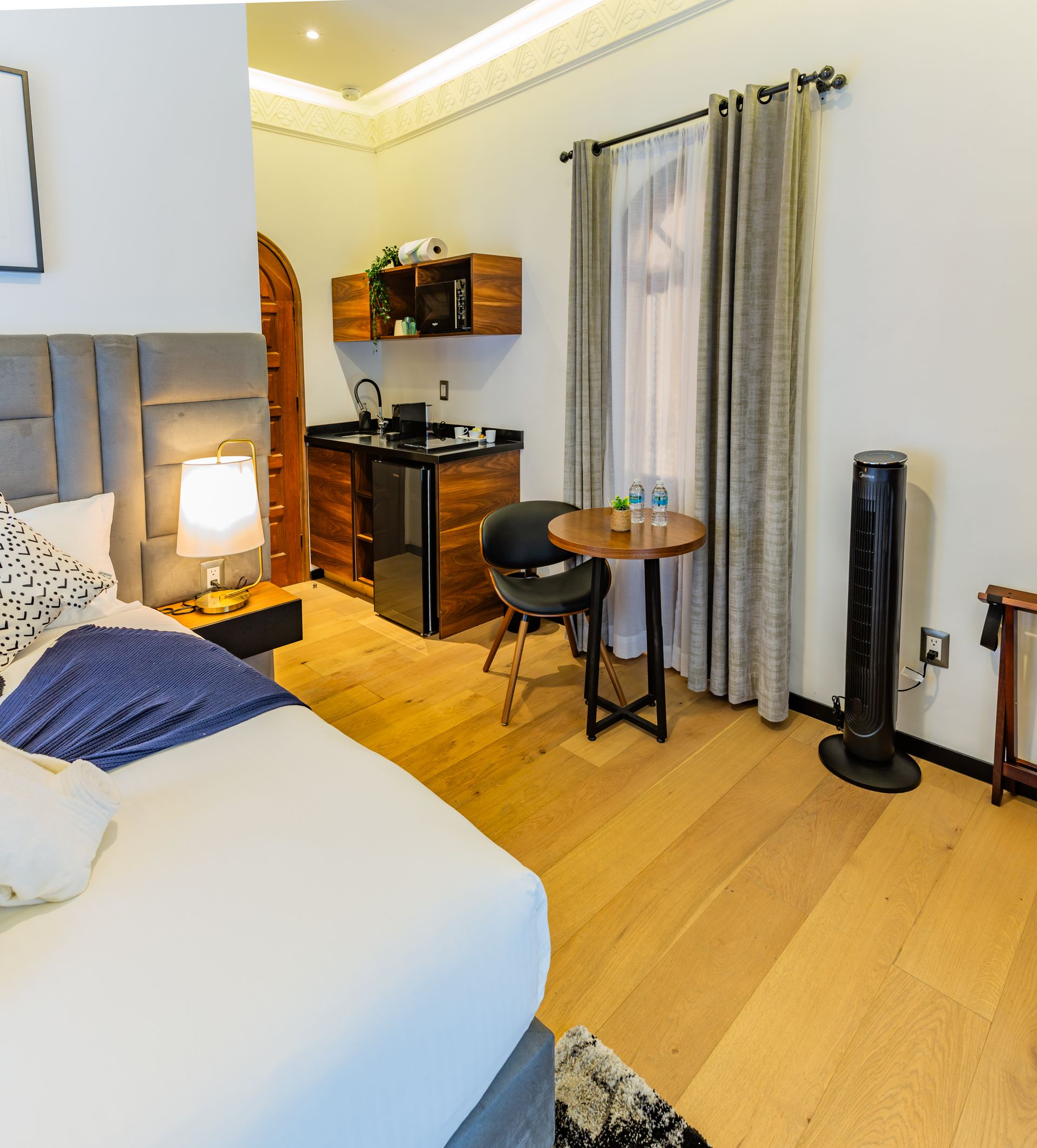 Un dormitorio con una cama grande y una mesa pequeña.