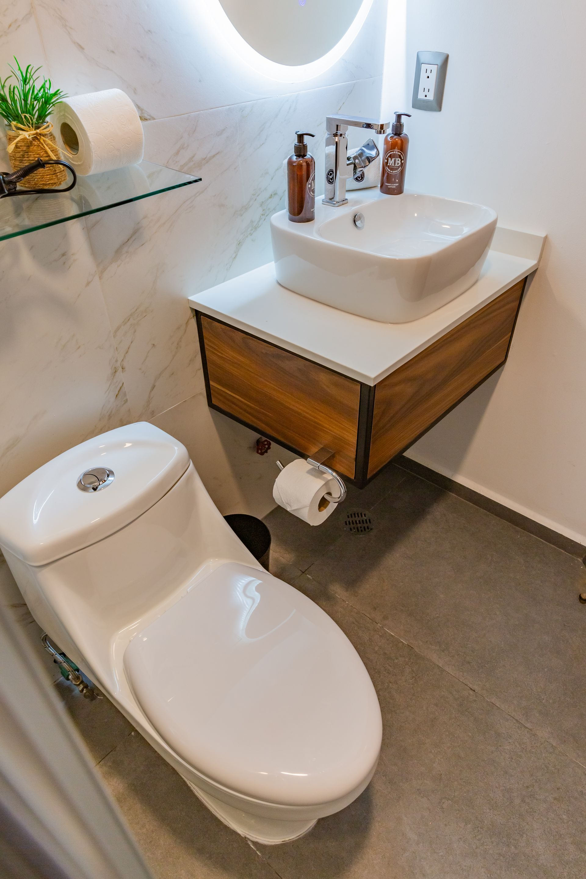 Un baño con inodoro, lavabo y espejo.