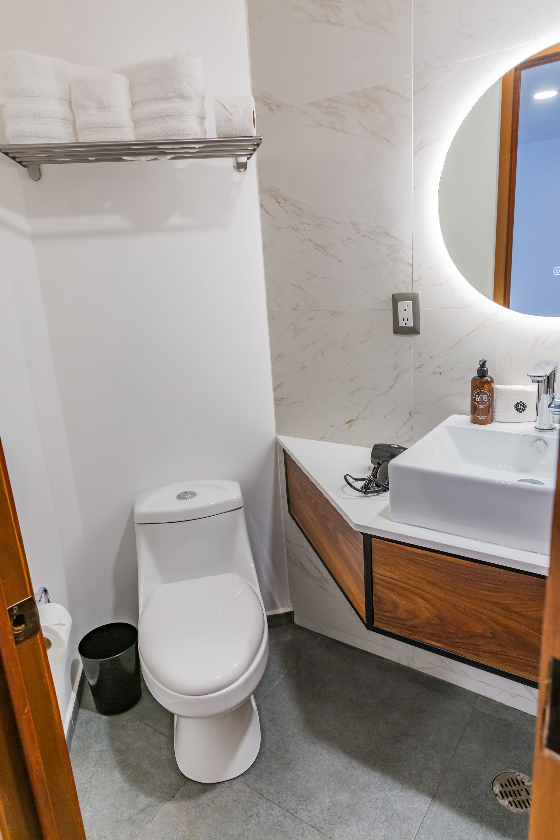 Un baño con inodoro, lavabo y espejo.