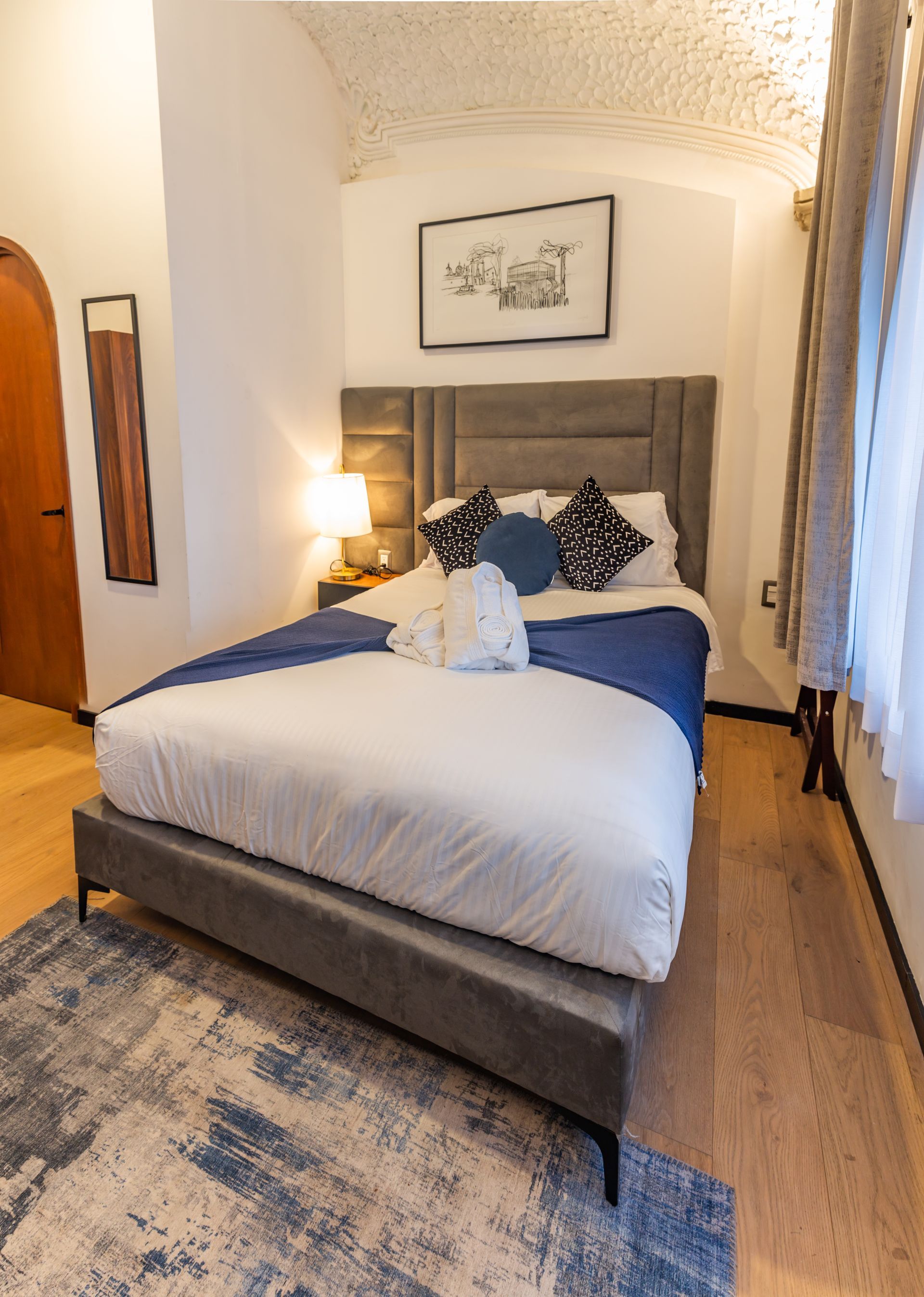 There is a large bed in the middle of the room.