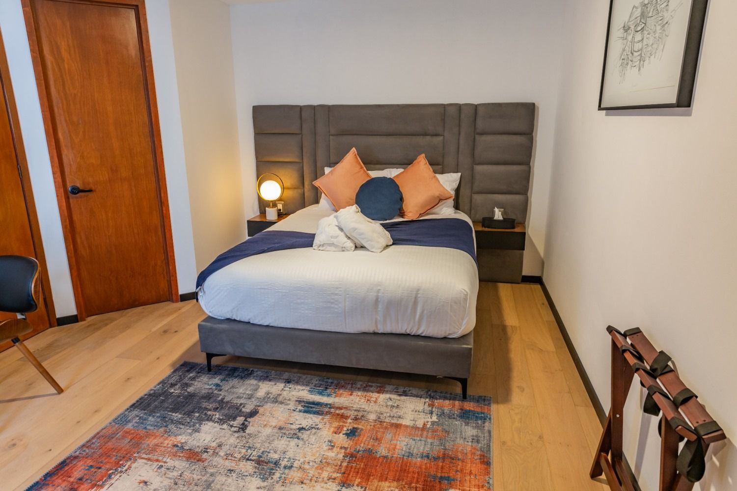 Una habitación de hotel con una cama grande y una alfombra.